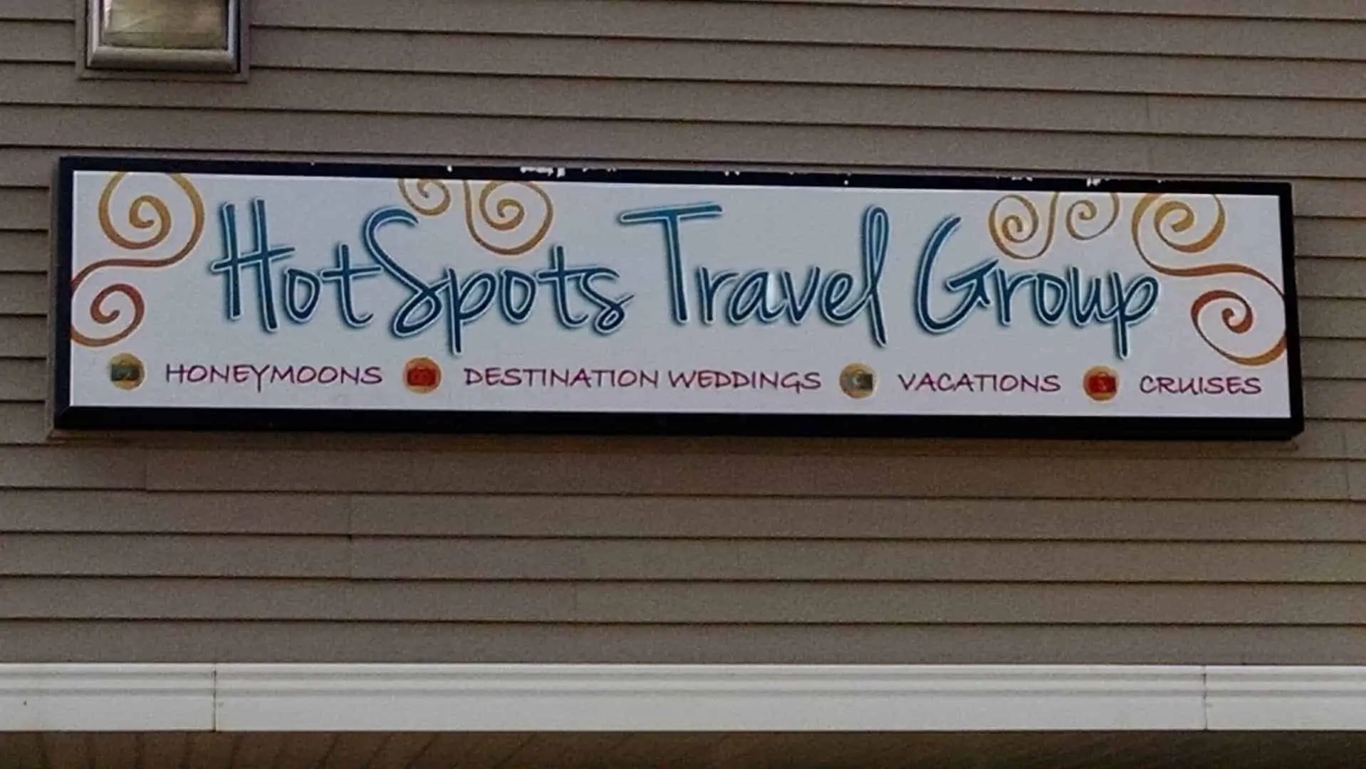 hot spots travel group outside sign