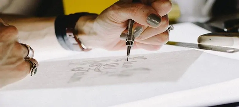 person drawing a design
